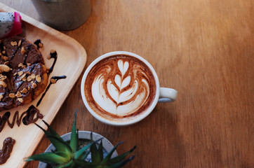 Hot Coffee on wooden table with chocolat on bread