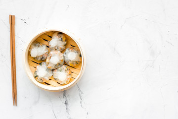 Dinner in Chinese restaurant with dim sum, stick on marble background top view space for text