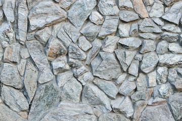 Wall of old gray stones. Stonework texture. Grunge background. Template and mockup for designers.