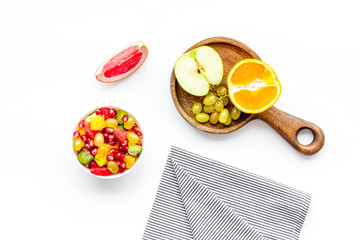 Healthy diet concept. Fruit salad near fresh fruits on white background top view