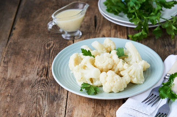 Boiled cauliflower with parsley and cream sauce