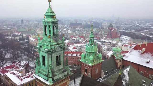 Aerial view of Wawel royal Castle and Cathedral, Vistula River, park, promenade and walking people in winter. Poland