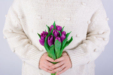 Large beautiful bouquet of lilac tulips in the girl hands close up