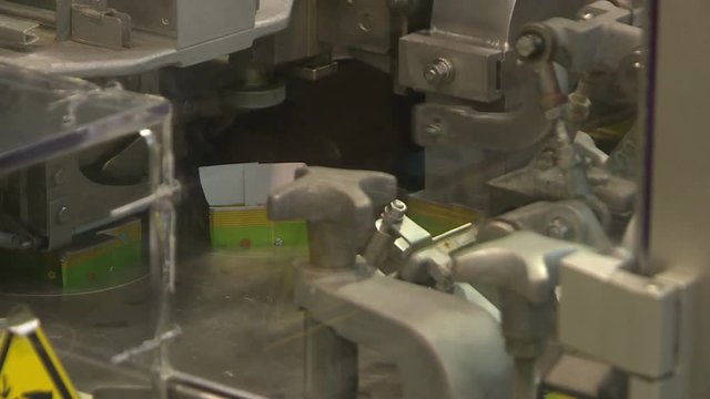 Production of butter at the dairy plant. The machine puts the oil in the bags and seals them