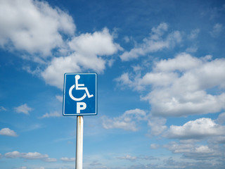 Blue handicap parking with white clouds and blue sky background