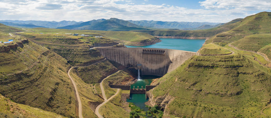 High resolution panorama of dam wall and surrounding landscape at Katse Dam in Lesotho during summer with a low water level on a clear sunny day - obrazy, fototapety, plakaty