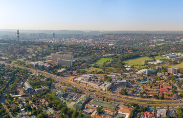 Obraz premium Panoramic aerial photo of Pretoria. Groenkloof Hospital, South African Bureau of Standards and University of Pretoria Groenkloof Campus close, Telkom Tower, city skyline and Magaliesberg hills further