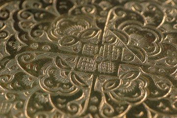 Eastern engraving on bronze, close-up