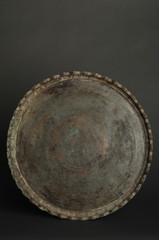 Fototapeta premium ancient oriental metal tray on dark background. antique bronze tableware