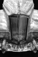 Detail of retro car with chrome bumper, radiator grille and shiny bodywork, classic vehicle...