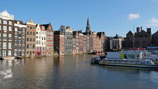 View on chanals with passenger ships in Damrak area of Amsterdam.