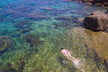 Tourist women swimming in clear bright sea water