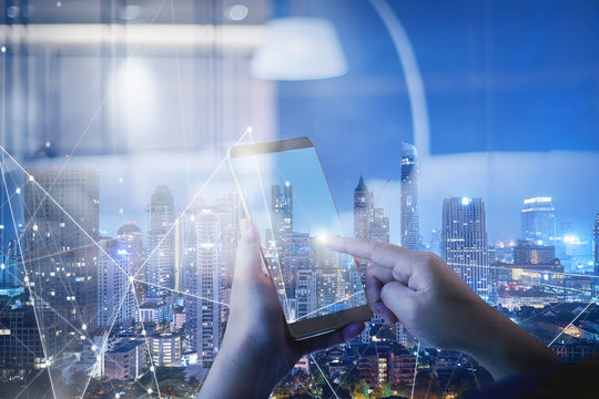 Unknown hand working on digital with smart city background, iot , binary , software program and 5g technology .