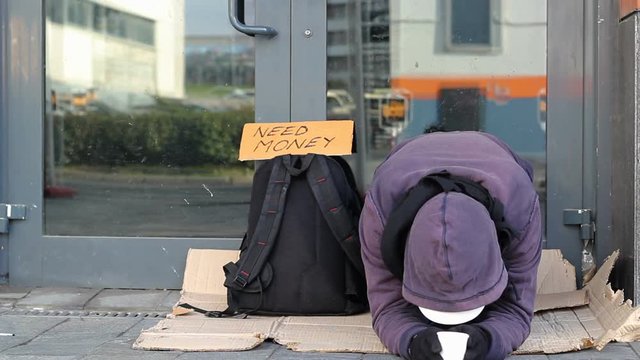 Homeless beggar man begging on the street
