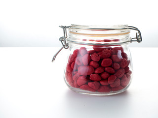 Red stone in a glass bottle