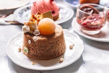 Fluffy sponge cake topping with coffee cream and ice sphere.