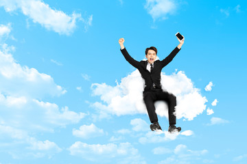 happy Young business man sitting on cloud