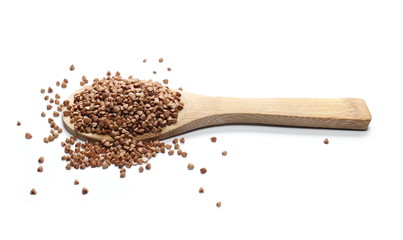 Buckwheat with wooden spoon isolated on white background