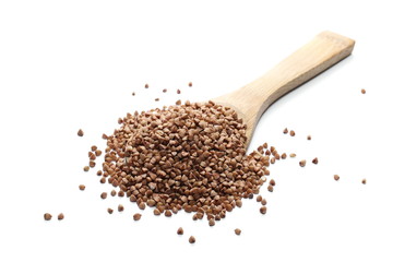 Buckwheat with wooden spoon isolated on white background