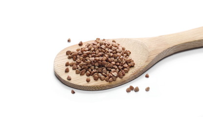 Buckwheat with wooden spoon isolated on white background
