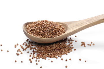 Buckwheat with wooden spoon isolated on white background