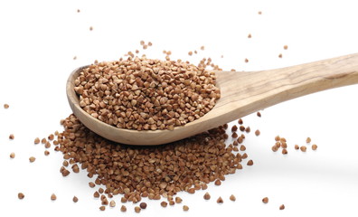Buckwheat with wooden spoon isolated on white background
