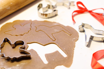 Baking christmas gingerbread cookies with a cookie cutter