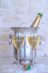 Celebration concept: two glasses of champagne and vintage bottle in the bucket