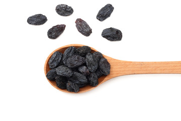 black raisins in wooden spoon isolated on white background. top view