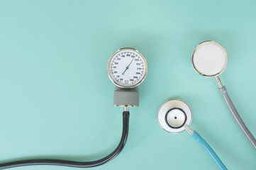 Blood pressure meter and stethoscope on blue background