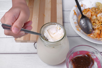 Asian little boy making a sandwich  for breakfast.