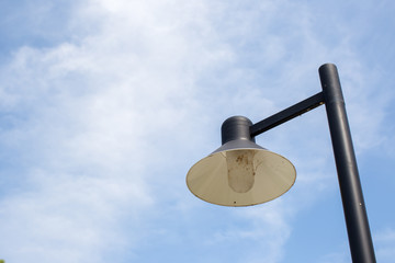 Close up vintage lamp and pole in the garden park and blue sky background. Electrical light in the night. image for background, wallpaper and objects.