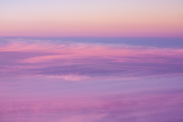 Aerial view across high level cloud as the sun sets