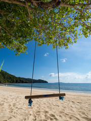 Wooden swing under tree on the beautiful beach, Scenery of beautiful destination island, Banana island, Philippines. November, 2018