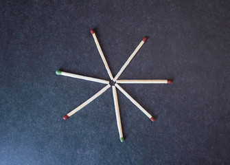 Several wooden matches on a black background.