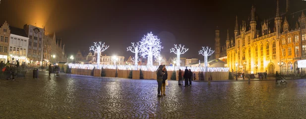 Poster Bruges, Belgium - November 24, 2018: Central Bruges Market Square by night decorated at Christmas. Oanoraic image. © ANADEL