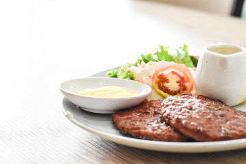 Beef steak, salad and french fries on a vintage wood background