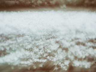 Snow lying on the bench. Snow on the streets of the city. The beginning of winter
