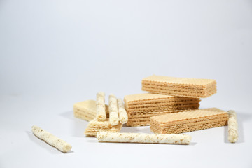 Wafer stick Stuffed with vanilla cream and milk on a white background