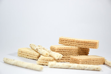 Wafer stick Stuffed with vanilla cream and milk on a white background