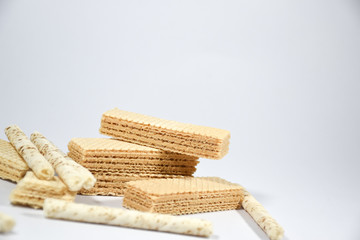 Wafer stick Stuffed with vanilla cream and milk on a white background