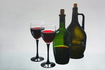 A glass of red wine and a bottle