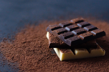A stack of different chocolate in on a black background.