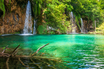 Waterfall at a turquoise lake. The Plitvice Lakes National Park, Croatia, Europe.