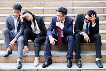 Fototapeta premium Asian businessmen sitting dismal because of unemployment.