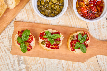 Obraz na płótnie Canvas Bruschetta or crostini with sun dried tomatoes and capers