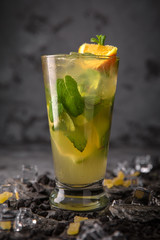 Alcoholic or non-alcoholic cocktail with lemon, lime and cucumber with the addition of liquor, vodka, champagne or martini. Cool drink.