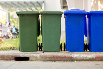 Obraz premium Garbage bin in public park.colorful trash bin.wheelie bin for rubbish,Public trash background,Big pile of garbage and waiste in black bags.