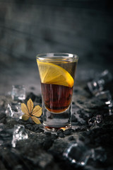 Alcoholic Black Magic cocktail in shot glass (shooters). Cool drink from strong vodka, whiskey and sweet liqueurs. Easy Bartenders Recipes and Ideas
