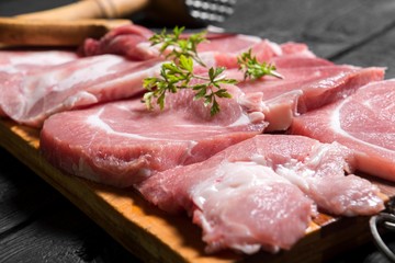 close up scene of pork steak meat with parsley. raw meat steaks